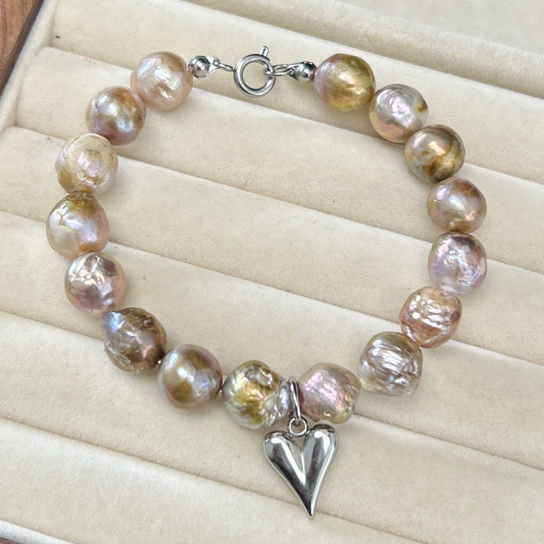 Bangle style curly pearls in metallic luster (Category: Bracelets) located in Lipa City. Submitted by avenueusco_ph (Listing ID 1471147211, Image 1). Description: Metallic luster curly pearls. ✨ With fishbites and growth color but not visible when worn. 🦪✨ 11mm pearl size Metallic luster in purple and pinkish color 8” Nonfading setting.