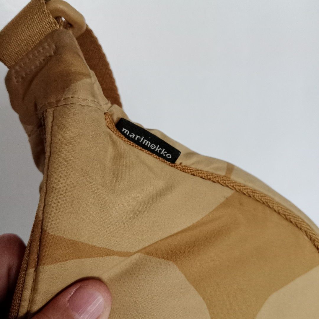 beige and brown sling bag (Category: Cross-body Bags) located in Manila. Submitted by mamapards17 (Listing ID 1471140638, Image 3). Description: beige and brown Uniqlo x Marimekko Round Mini Shoulder Bag featuring a circular geometric pattern..