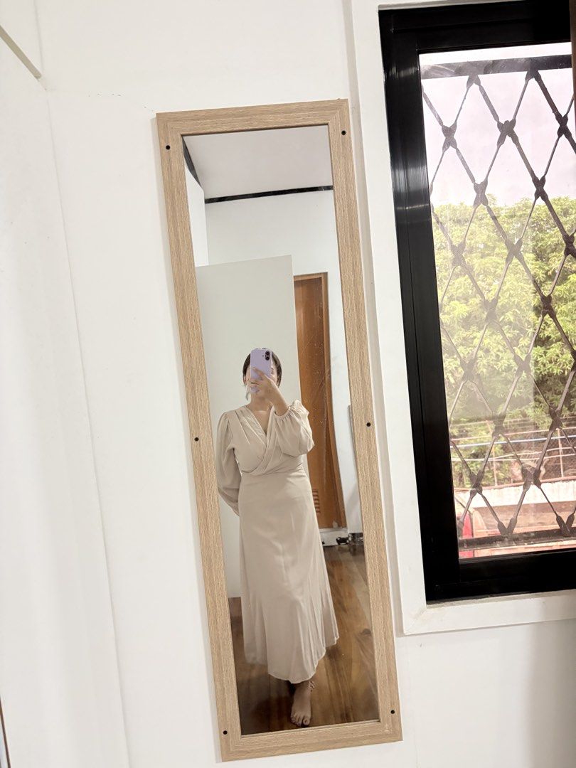 Beige Long Sleeve Midi Wrap Dress (Category: Dresses) located in Makati City. Submitted by krizzzyy (Listing ID 1471147769, Image 2). Description: - Color: Neutral beige (goes with everything) - Style: Crossover V-neck wrap design with long sleeves - Fit: Gathered waistline with a slight flare at the bottom hem - Length: Midi (hits around mid-calf) - Material: Soft and comfortable fabric - Condition: Excellent, worn only a few times, clean inside