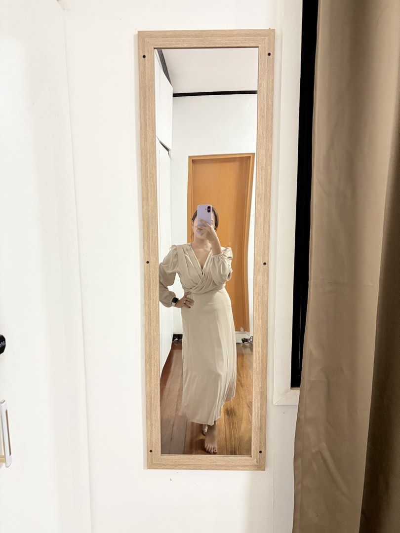 Beige Long Sleeve Midi Wrap Dress (Category: Dresses) located in Makati City. Submitted by krizzzyy (Listing ID 1471147769, Image 1). Description: - Color: Neutral beige (goes with everything) - Style: Crossover V-neck wrap design with long sleeves - Fit: Gathered waistline with a slight flare at the bottom hem - Length: Midi (hits around mid-calf) - Material: Soft and comfortable fabric - Condition: Excellent, worn only a few times, clean inside