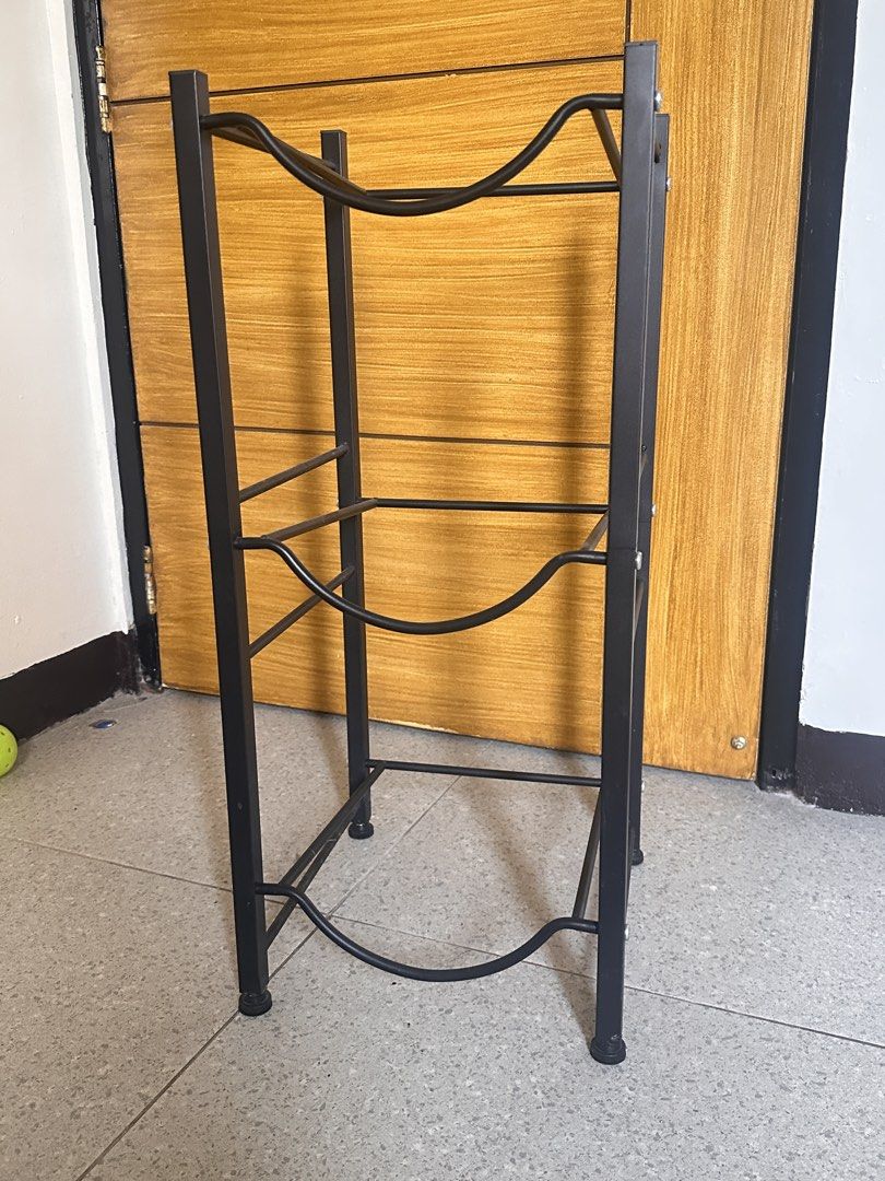 Black 3-Tier Water Jug Holder Storage Rack (Category: Bathroom & Kitchen Fixtures) located in Manila. Submitted by aaalp (Listing ID 1471131822, Image 2). Description: - Holds up to 3 water bottles vertically to save valuable floor space - Sturdy black steel construction with curved supports for secure storage - Equipped with protective rubber feet to prevent floor scratches - Compact and versatile design ideal for kitchens, offices, or utility r