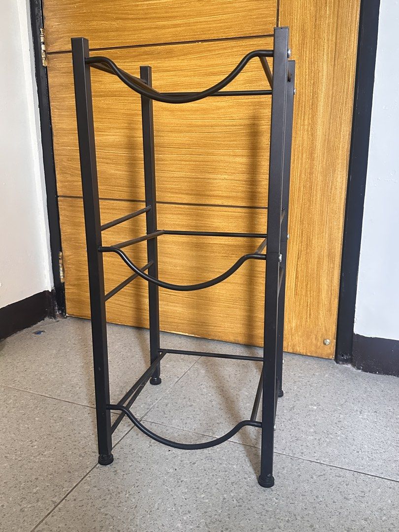 Black 3-Tier Water Jug Holder Storage Rack (Category: Bathroom & Kitchen Fixtures) located in Manila. Submitted by aaalp (Listing ID 1471131822, Image 1). Description: - Holds up to 3 water bottles vertically to save valuable floor space - Sturdy black steel construction with curved supports for secure storage - Equipped with protective rubber feet to prevent floor scratches - Compact and versatile design ideal for kitchens, offices, or utility r