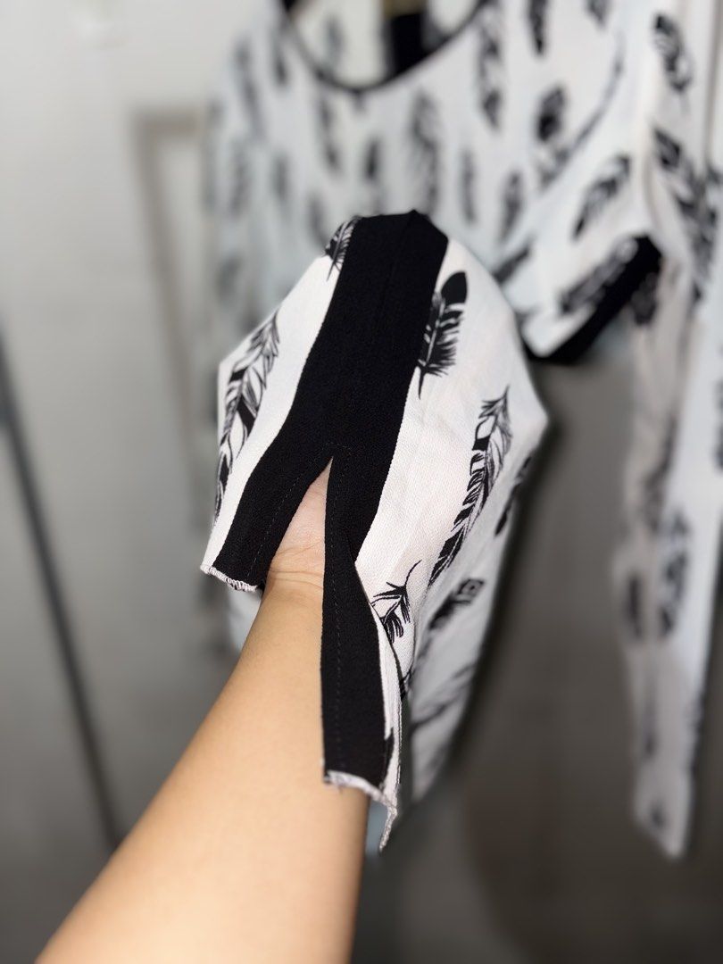 Black and White Feather Print Long Sleeve Blouse (Category: Longsleeves) located in Cavite. Submitted by earthread (Listing ID 1471188529, Image 3). Description: - White long sleeve top with stylish all-over black feather pattern - Contrasting black round neckline, side stripes, and solid black back panel - Lightweight and comfortable fabric ideal for daily wear - High-low hem with side slits for easy movement and a flattering fit - Versatile cas