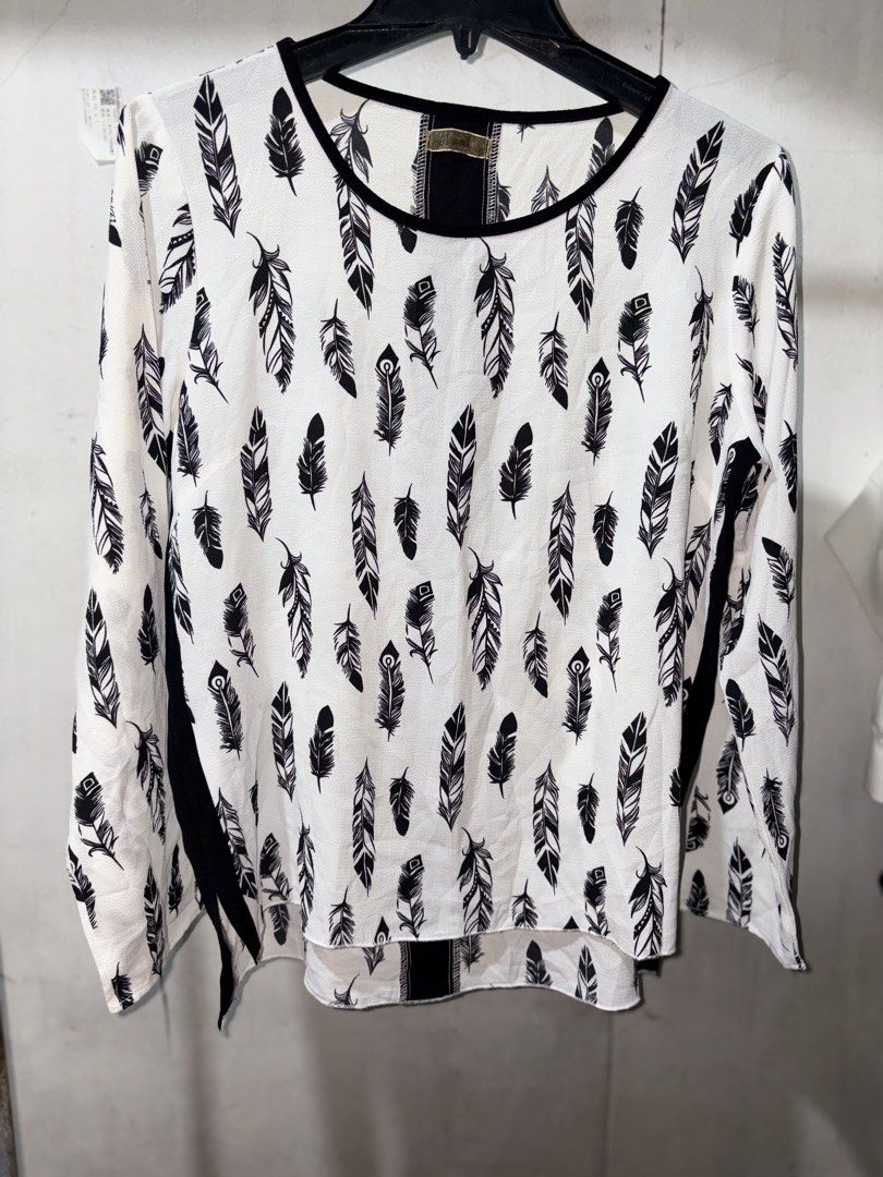 Black and White Feather Print Long Sleeve Blouse (Category: Longsleeves) located in Cavite. Submitted by earthread (Listing ID 1471188529, Image 1). Description: - White long sleeve top with stylish all-over black feather pattern - Contrasting black round neckline, side stripes, and solid black back panel - Lightweight and comfortable fabric ideal for daily wear - High-low hem with side slits for easy movement and a flattering fit - Versatile cas