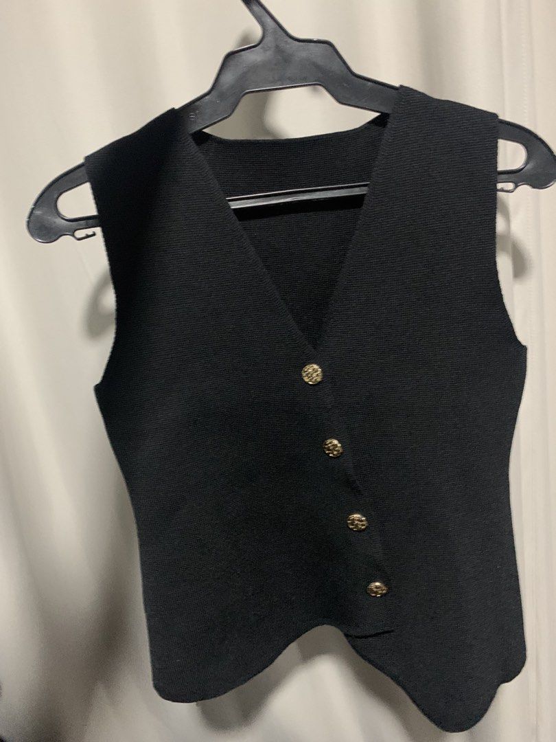 Black knit vest with gold buttons (Category: Sleeveless) located in Manila. Submitted by decluterthings888 (Listing ID 1471233490, Image 1). Description: - Color: Classic Black. xxx no brand xxx - Design: V-neck, sleeveless, slightly asymmetrical hem - Details: Four eye-catching gold decorative buttons - Material: Soft and comfortable knit fabric - Styling: Perfect for layering over button-downs or wearing on its own - Condition: Brand new / Exce