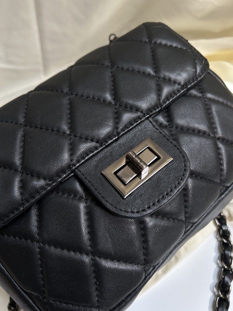 Black Quilted Shoulder Bag with Chain Strap (Category: Shoulder Bags) located in Cagayan de Oro. Submitted by elviecup (Listing ID 1471194276, Image 2). Description: - Style: Classic black quilted shoulder bag with diamond pattern - Hardware: Silver-tone metal twist lock on front flap - Strap: Dark metallic chain threaded with black material - Size: Compact, perfect for daily essentials - Quality: Clean stitching throughout for a polished look - 
