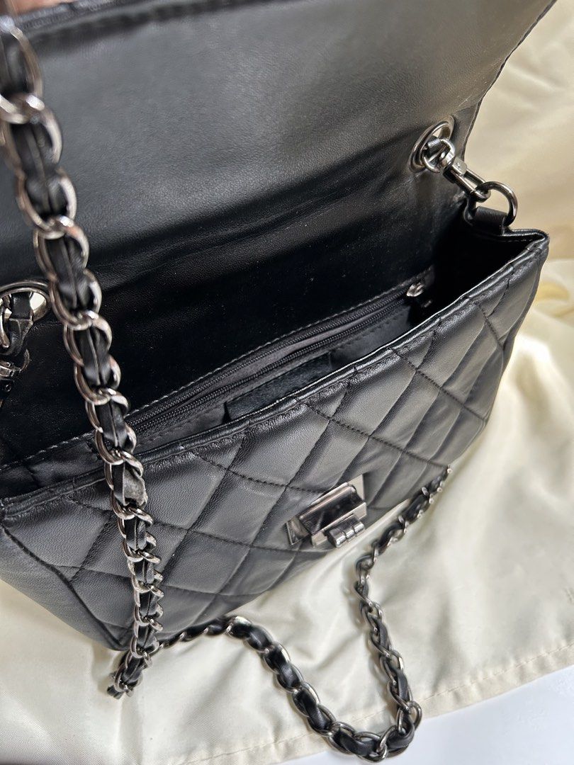 Black Quilted Shoulder Bag with Chain Strap (Category: Shoulder Bags) located in Cagayan de Oro. Submitted by elviecup (Listing ID 1471194276, Image 3). Description: - Style: Classic black quilted shoulder bag with diamond pattern - Hardware: Silver-tone metal twist lock on front flap - Strap: Dark metallic chain threaded with black material - Size: Compact, perfect for daily essentials - Quality: Clean stitching throughout for a polished look - 