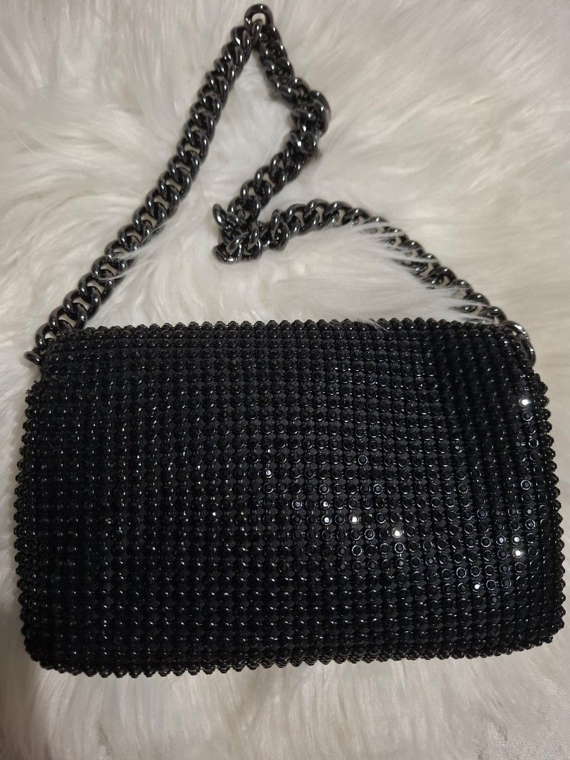 Black rhinestone chain strap crossbody evening bag (Category: Luxury Bags & Wallets) located in Dasmarinas. Submitted by safehawk.7efe62 (Listing ID 1471258212, Image 2). Description: - Style: Evening wear / Party handbag - Color/Design: Fully covered in sparkly black rhinestones - Hardware: Matching black rhinestone clasp with dark metal accents - Strap: Removable chunky dark metal chain - Closure: Secure flap closure - Size: Compact and handy f