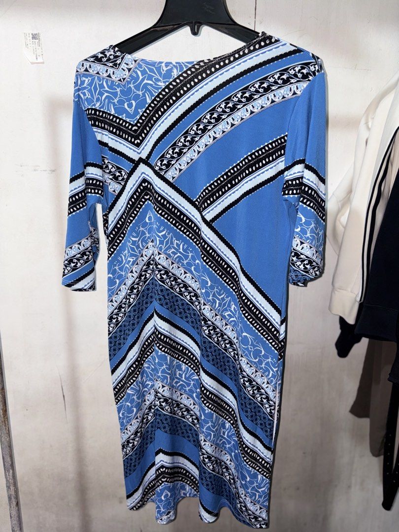 Blue and White Geometric Pattern Midi Dress (Category: Dresses) located in Cavite. Submitted by earthread (Listing ID 1471187811, Image 2). Description: - Style: Blue patterned midi dress with geometric and floral prints - Neckline & Sleeves: Flattering V-neck with three-quarter length sleeves - Fit & Fabric: Stretchy, comfortable fabric for all-day wear - Design: Bold diagonal lines creating a striking visual pattern - Versatility: Easy to dress