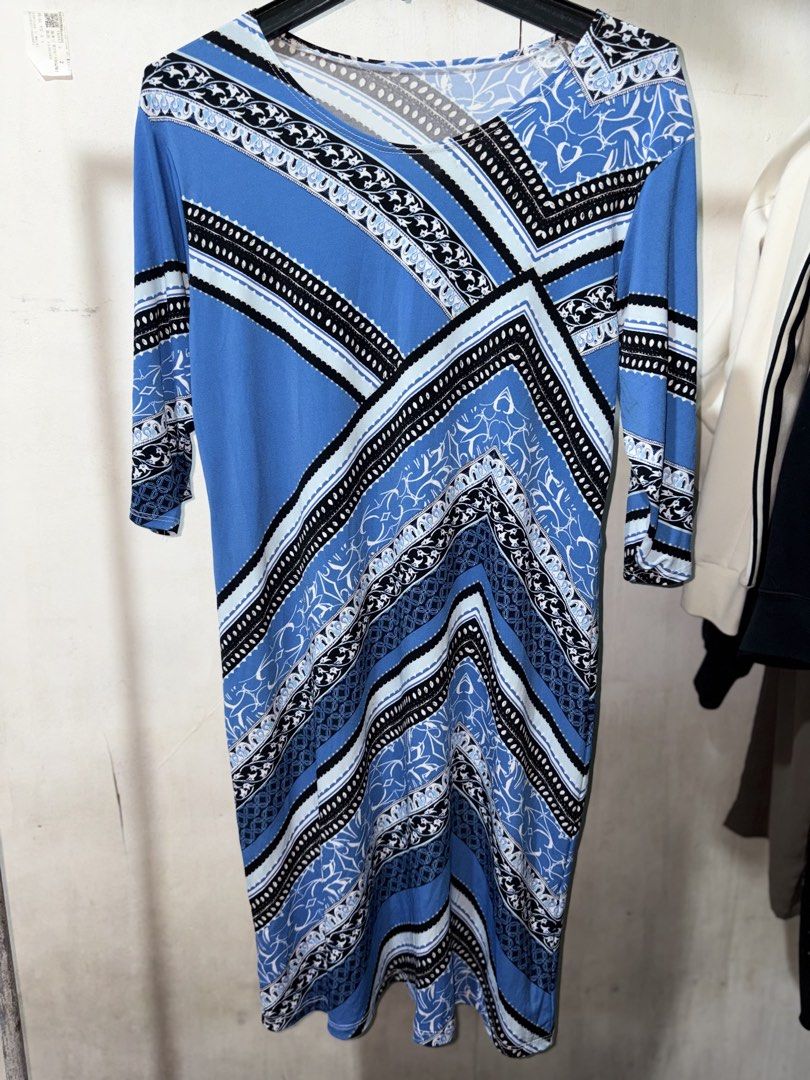 Blue and White Geometric Pattern Midi Dress (Category: Dresses) located in Cavite. Submitted by earthread (Listing ID 1471187811, Image 1). Description: - Style: Blue patterned midi dress with geometric and floral prints - Neckline & Sleeves: Flattering V-neck with three-quarter length sleeves - Fit & Fabric: Stretchy, comfortable fabric for all-day wear - Design: Bold diagonal lines creating a striking visual pattern - Versatility: Easy to dress