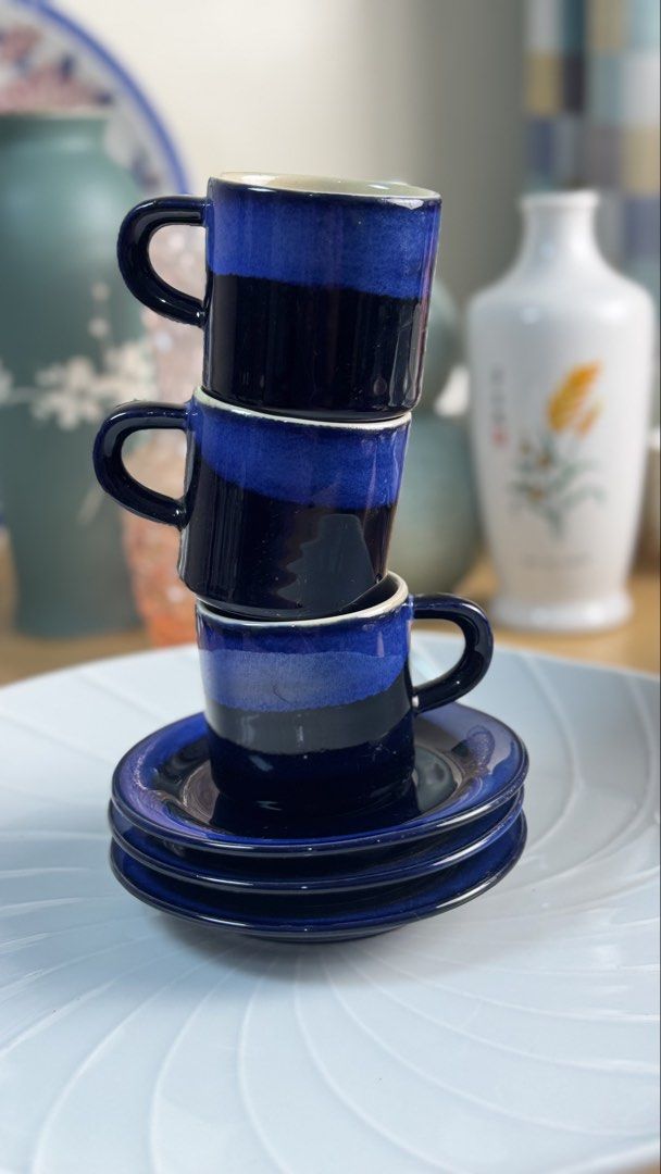 Blue Ceramic Espresso Cups And Saucers Stackable Set (Category: Coffee & Tea Tableware) located in Masinloc. Submitted by kristineba02273 (Listing ID 1471150538, Image 1). Description: - Set of 3 ceramic espresso cups with matching saucers - Beautiful deep blue glaze with a lighter blue gradient band and cream interior - Stackable design helps save precious cabinet space - Glossy and smooth finish, perfect for morning shots or after-dinner espres