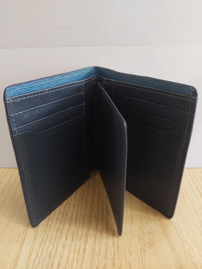 Blue leather bifold wallet with multiple card slots (Category: Wallets & Card holders) located in Davao. Submitted by oddlion_769da3 (Listing ID 1471182919, Image 3). Description: - Material: Premium blue leather with a textured outer finish - Branding: Subtle debossed logo design on the front - Interior: Dark lining with multiple card slots and cash compartments - Size: Compact design, fits easily in pockets - Condition: Brand new and ready to s