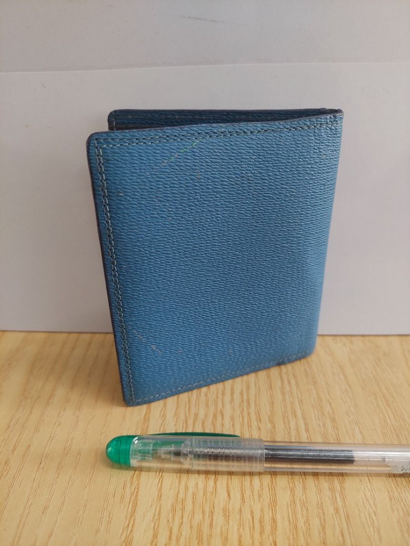 Blue leather bifold wallet with multiple card slots (Category: Wallets & Card holders) located in Davao. Submitted by oddlion_769da3 (Listing ID 1471182919, Image 2). Description: - Material: Premium blue leather with a textured outer finish - Branding: Subtle debossed logo design on the front - Interior: Dark lining with multiple card slots and cash compartments - Size: Compact design, fits easily in pockets - Condition: Brand new and ready to s