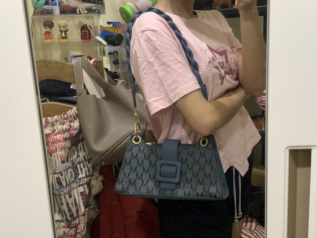 Blue Monogram Shoulder Bag with Braided Strap (Category: Shoulder Bags) located in Manila. Submitted by chelle_thrifted_shack (Listing ID 1471257991, Image 2). Description: - Trendy blue denim bag with all-over M monogram pattern - Eye-catching chunky blue front buckle strap with gold-tone hardware rings - Comfortable braided shoulder strap designed for under-arm carry - Secure top zipper closure to keep your essentials safe - EUC, stylish, and r
