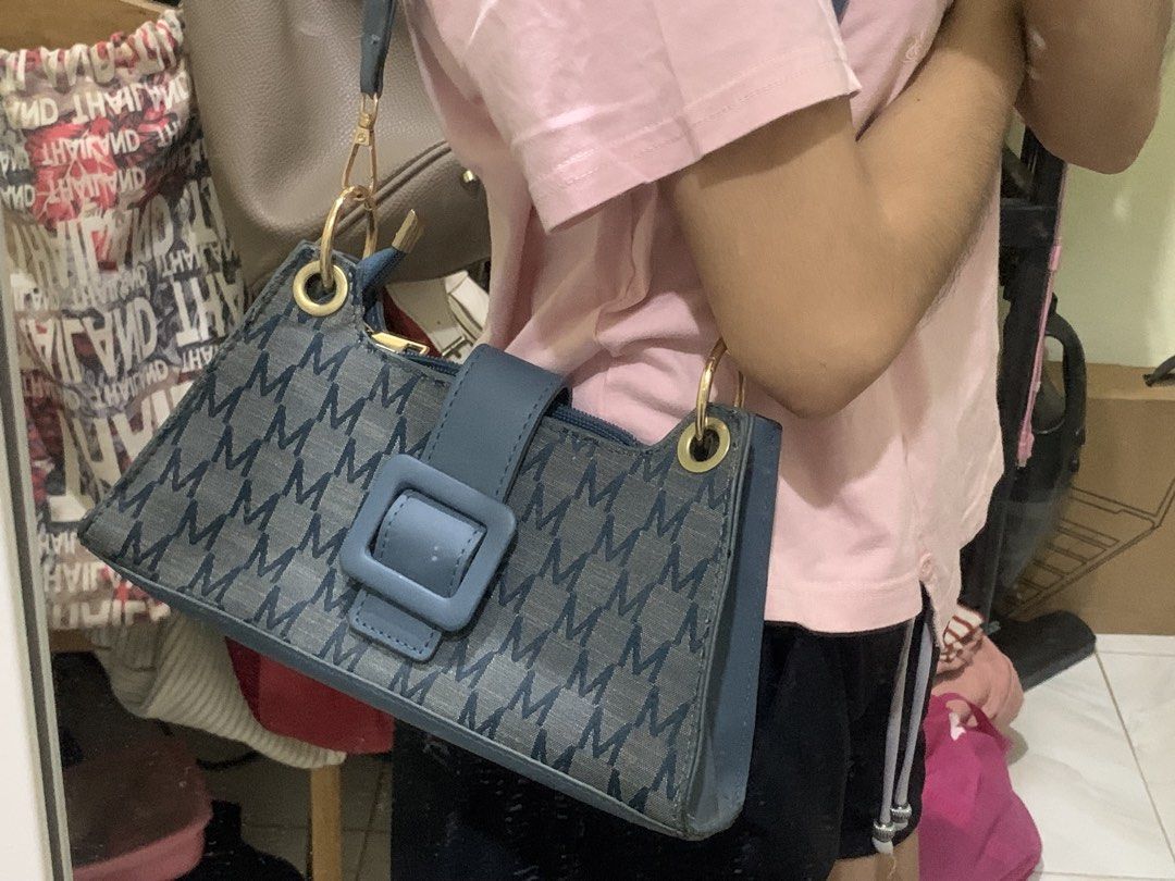 Blue Monogram Shoulder Bag with Braided Strap (Category: Shoulder Bags) located in Manila. Submitted by chelle_thrifted_shack (Listing ID 1471257991, Image 3). Description: - Trendy blue denim bag with all-over M monogram pattern - Eye-catching chunky blue front buckle strap with gold-tone hardware rings - Comfortable braided shoulder strap designed for under-arm carry - Secure top zipper closure to keep your essentials safe - EUC, stylish, and r