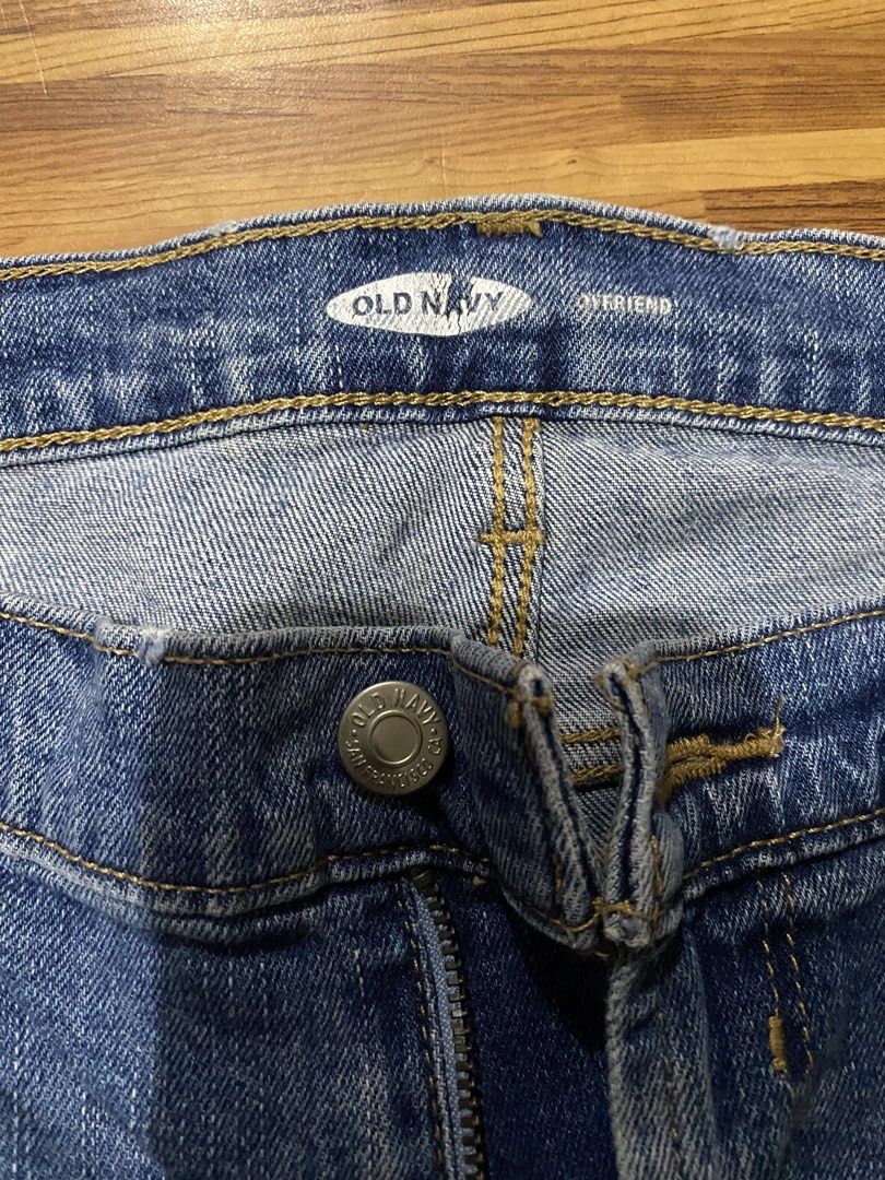 Boyfriend Jeans (Category: Jeans) located in Manila. Submitted by ellieeeeee0293929 (Listing ID 1471123345, Image 2). Description: - Brand: Old Navy - Style: Boyfriend jeans with distressed raw hem detail - Wash: Medium blue with yellow contrast stitching - Rise: Mid rise with front button and zipper closure - Design: Classic five-pocket styling - Material: Soft, comfortable denim.