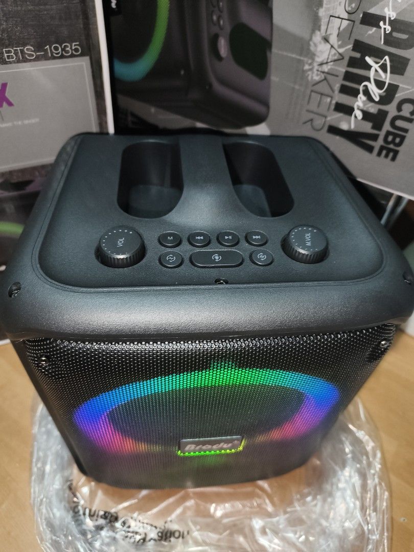 Brodu BTS-1935 iKaraoke Box Professional System (Category: Soundbars, Speakers & Amplifiers) located in Manila. Submitted by reascheyss51406 (Listing ID 1471120119, Image 3). Description: - Model: Brodu BTS-1935 Portable Karaoke Speaker - Color/Design: Black cube shape with vibrant front RGB colorful ring light - Includes: 1 wireless microphone with digital display and orange control buttons - Controls: Top panel with master volume knobs, track n