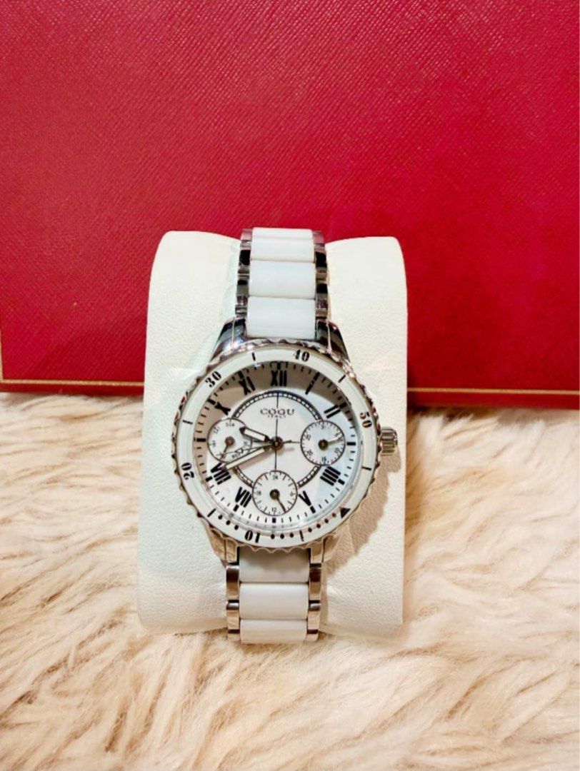 C0GU Italy quartz wristwatch (Category: Women's Watches) located in Manila. Submitted by annafinds (Listing ID 1471286057, Image 3). Description: C0GU Italy quartz wristwatch featuring a white dial with Roman numerals, a white-accented rotating bezel, and a ceramic and-silver link bracelet. ₱3,999 Open for layaway..
