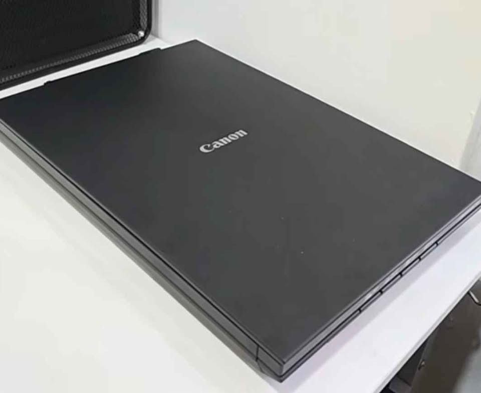 Canon flatbed scanner black office equipment (Category: Printers, Scanners & Copiers) located in Caloocan City. Submitted by safelion.8ba3d1 (Listing ID 1471168071, Image 1). Description: - Brand: Canon - Color/Finish: Black with clean matte surface and silver logo - Condition: Fully functional, powers up normally, scratch-free glass - Use: Ideal for standard office documents and photos - Reason for selling: Upgraded to an all-in-one printer.