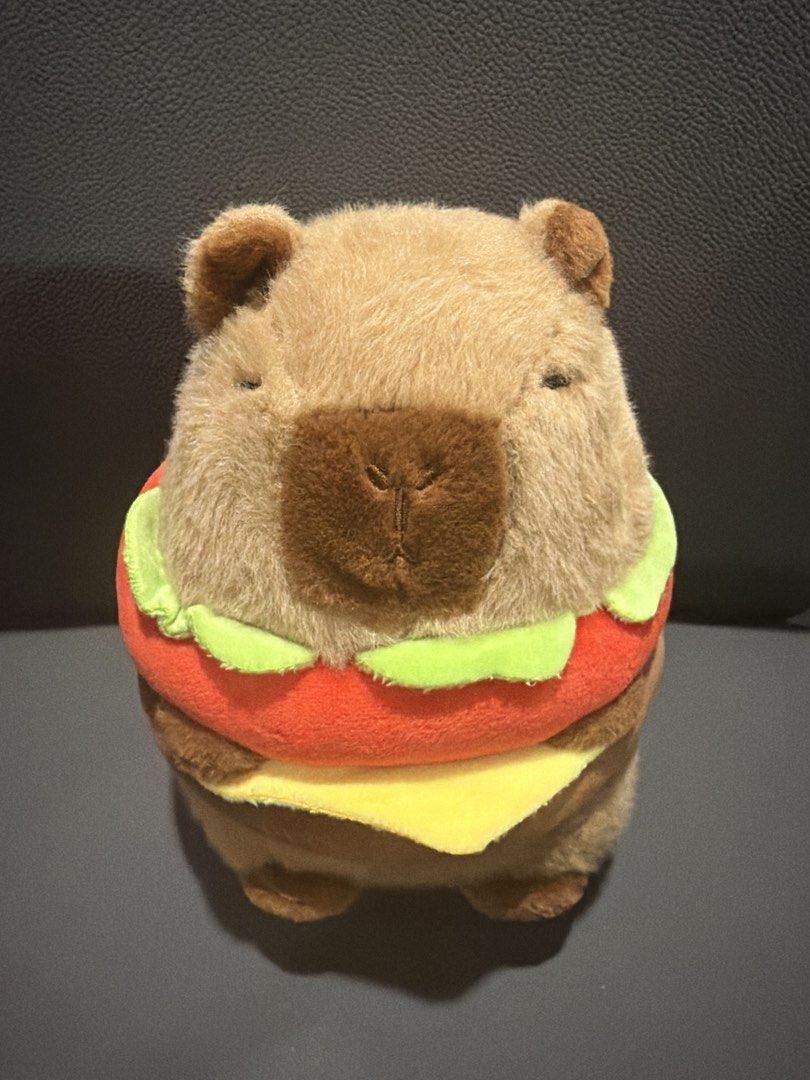 Capybara burger plush toy stuffed animal (Category: Plushies & Soft Toys) located in San Juan City. Submitted by lilminey (Listing ID 1471220540, Image 1). Description: - Adorable capybara plush toy dressed as a delicious burger - Features soft brown fur, detailed stitching, and lettuce, tomato, and cheese layers - Stuffed with super soft material for maximum huggability - Clean exterior surface, well-maintained - Perfect novelty gift for collect