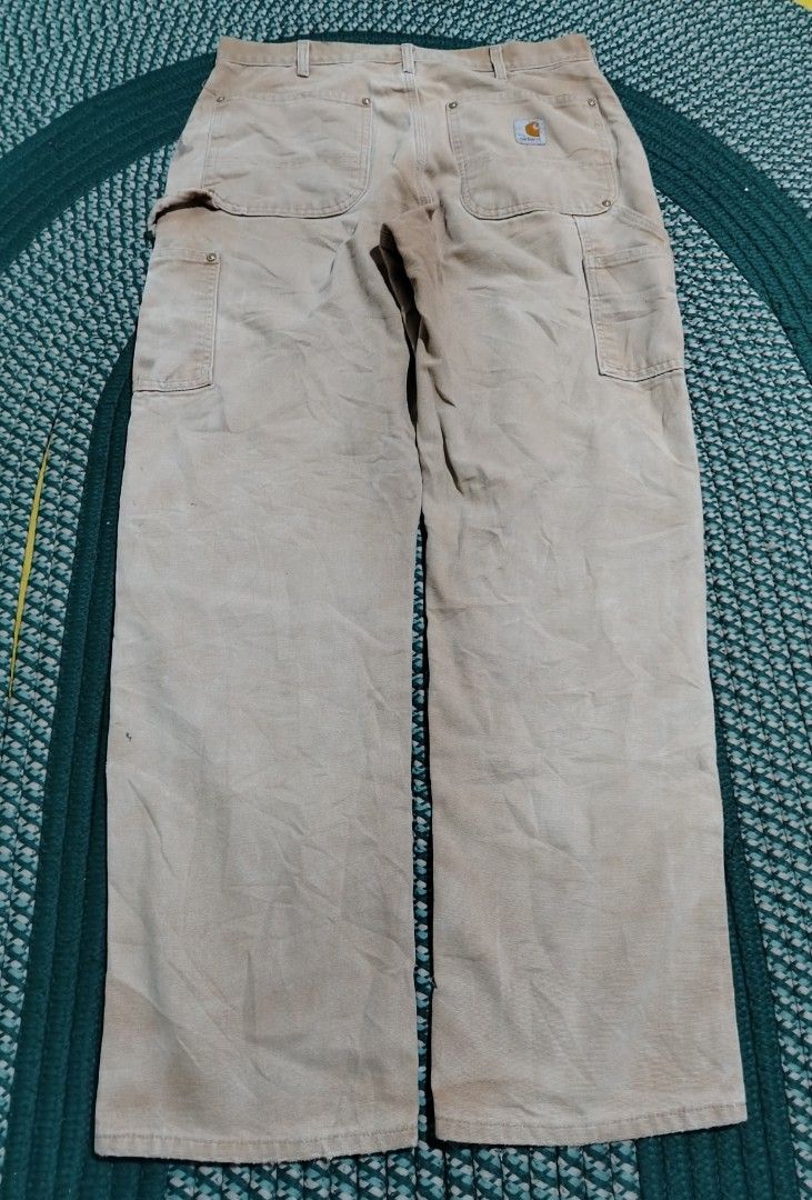 Carhartt Double Front Work Pants Tan (Category: Jeans) located in Lucena. Submitted by thrifteditem (Listing ID 1471207087, Image 2). Description: - Authentic Carhartt double-front work pants in classic tan duck canvas - Built for durability with heavy-duty cotton construction and metal rivets at stress points - Equipped with practical utility pockets and a back hammer loop - Genuine worn-in character with natural fading from actual job site use 