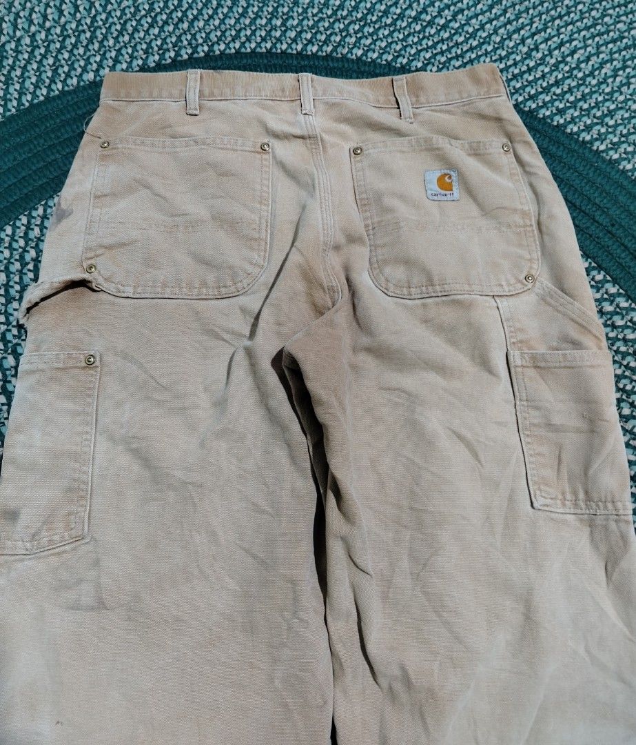 Carhartt Double Front Work Pants Tan (Category: Jeans) located in Lucena. Submitted by thrifteditem (Listing ID 1471207087, Image 3). Description: - Authentic Carhartt double-front work pants in classic tan duck canvas - Built for durability with heavy-duty cotton construction and metal rivets at stress points - Equipped with practical utility pockets and a back hammer loop - Genuine worn-in character with natural fading from actual job site use 