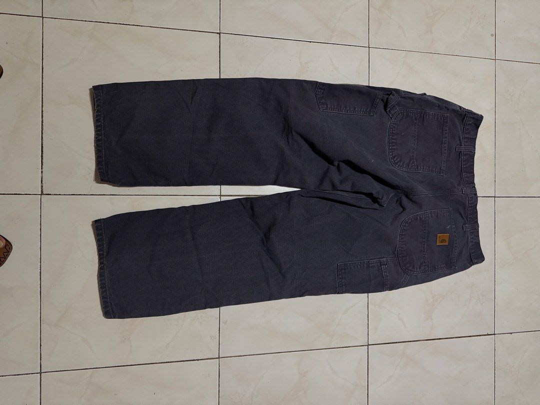Carthus Dark Grey Carpenter Pants Canvas Workwear (Category: Jeans) located in Davao. Submitted by nobleangel (Listing ID 1471137443, Image 3). Description: - Brand/Model: Carthus Carpenter Pants - Color: Dark grey with slight fading - Material: Heavy cotton canvas - Features: Tool pockets, hammer loop, and woven brand patch - Fit: Regular fit with wide legs - Condition: Pre-loved with minor wear marks.