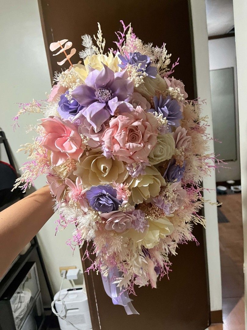 Cascading wedding bouquet - Dried Flower (Category: Flowers & Bouquets) located in Valenzuela. Submitted by circatoji (Listing ID 1471292582, Image 3). Description: - Custom cascade style wedding dried flower bouquet - Color palette: Pastel pink, purple, cream, and soft yellow - Features mixed dried fillers, grasses, and elegant hanging ribbon tails - Condition: Used once for photos and ceremony - Quality: Holds shape well with minimal shedding.