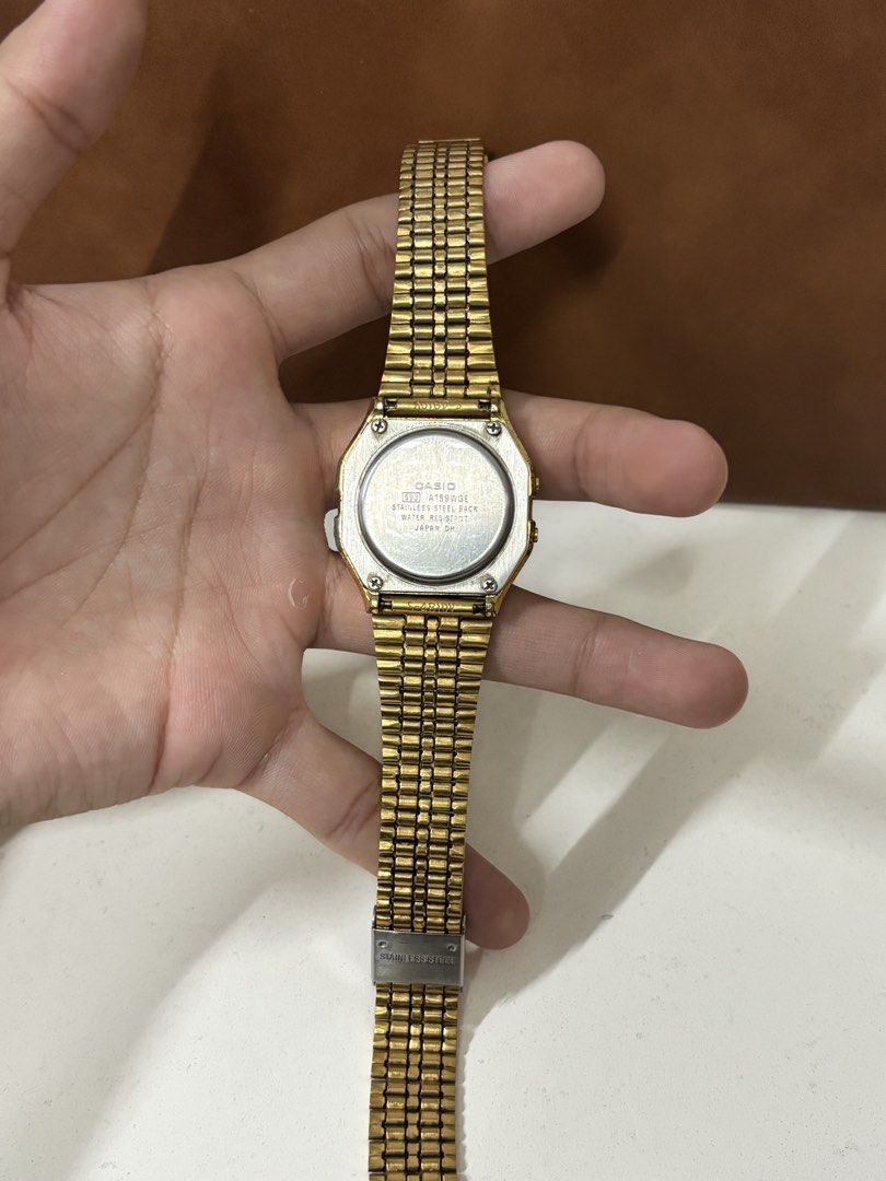 Casio A159WGE Gold Vintage Digital Watch (Category: Women's Watches) located in Manila. Submitted by mharkie (Listing ID 1471285330, Image 2). Description: - Iconic retro gold-tone Casio digital watch with stainless steel back (Module 593, Japan DH) - Fully functioning digital display featuring time, date, alarm, and stopwatch - Adjustable link bracelet with secure stainless steel clasp - Exhibits natural scuffs and vintage patina from regular we