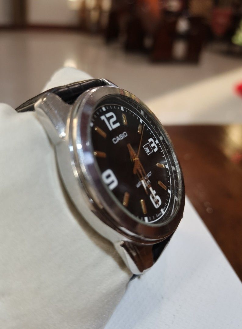 Casio MTP-1314 Quartz Watch with Black Leather Strap (Category: Men's Watches) located in Angono. Submitted by allenpaul26 (Listing ID 1471138147, Image 3). Description: - Brand: Casio (Model: MTP-1314) - Dial: Black textured dial with gold-tone hands and large Arabic numerals - Features: Date display window at 3 o'clock - Build: Stainless steel case with genuine black leather strap - Movement: Reliable Japan movement - Water Resistance: Up to 50