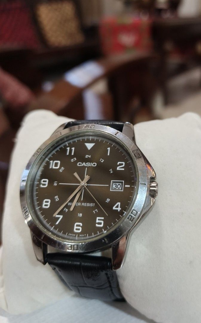 Casio Water Resist Analog Watch with Black Leather Strap (Category: Men's Watches) located in Angono. Submitted by allenpaul26 (Listing ID 1471137985, Image 1). Description: - Brand: Casio Analog Watch - Dial: Brown with clear Arabic numerals and 24-hour inner markings - Features: Date window at the 3 o'clock position - Strap: Black faux-croc leather strap with silver-tone buckle closure - Condition: Stainless steel bezel shows minor signs of wea