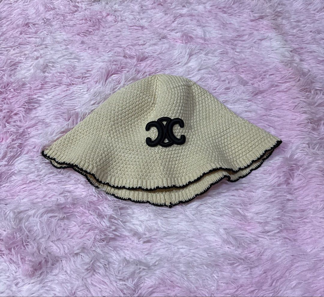 Celine Knit Bucket Hat Beige Black (Category: Hats & Beanies) located in Bacoor. Submitted by micsr (Listing ID 1471223871, Image 2). Description: - Color: Beige knit with black brim trim - Design: Iconic black embroidered Celine Triomphe logo on the front - Material: Soft woven texture with a comfortable inner lining ribbon - Style: Trendy and versatile sunny day accessory.