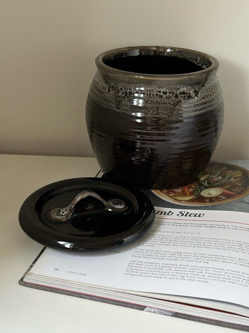 Ceramic Crock / Jar with Lid (1kg Capacity) (Category: Other Kitchenware & Tableware) located in Quezon City. Submitted by curatedfindsy (Listing ID 1471246164, Image 2). Description: Japanese Tenmoku Style Glazed Ceramic Crock / Canister with Lid (1kg Capacity) ₱450 Dimensions: 15.3cm d x 15.3cm h, opening 13.6cm Quality: Excellent Add a touch of rustic craftsmanship to your kitchen or home display with this dark stoneware canister/crock. Featur