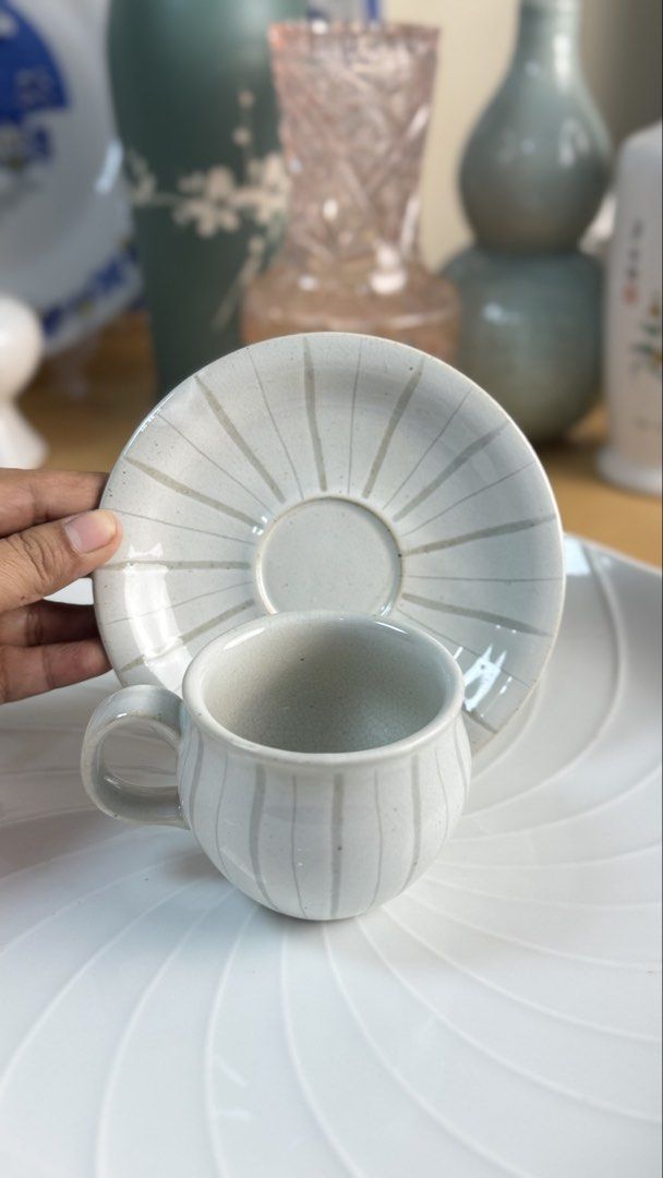 Ceramic Tea Cup and Saucer Set with Striped Pattern (Category: Coffee & Tea Tableware) located in Masinloc. Submitted by kristineba02273 (Listing ID 1471146019, Image 1). Description: - Handmade ceramic tea cups with matching saucers (Set of 2) - Light grey glaze featuring darker vertical stripes and a unique crackle effect - Minimalist Japanese/Korean pottery aesthetic that fits any neutral table setting - Practical stackable design for easy and