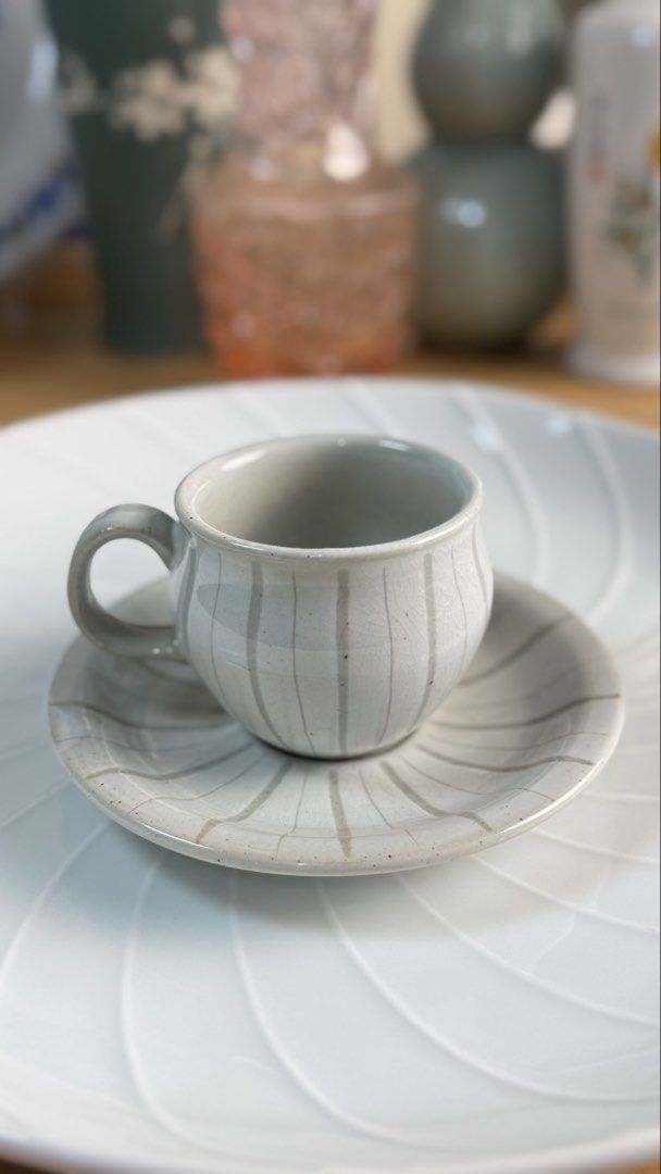 Ceramic Tea Cup and Saucer Set with Striped Pattern (Category: Coffee & Tea Tableware) located in Masinloc. Submitted by kristineba02273 (Listing ID 1471146019, Image 2). Description: - Handmade ceramic tea cups with matching saucers (Set of 2) - Light grey glaze featuring darker vertical stripes and a unique crackle effect - Minimalist Japanese/Korean pottery aesthetic that fits any neutral table setting - Practical stackable design for easy and