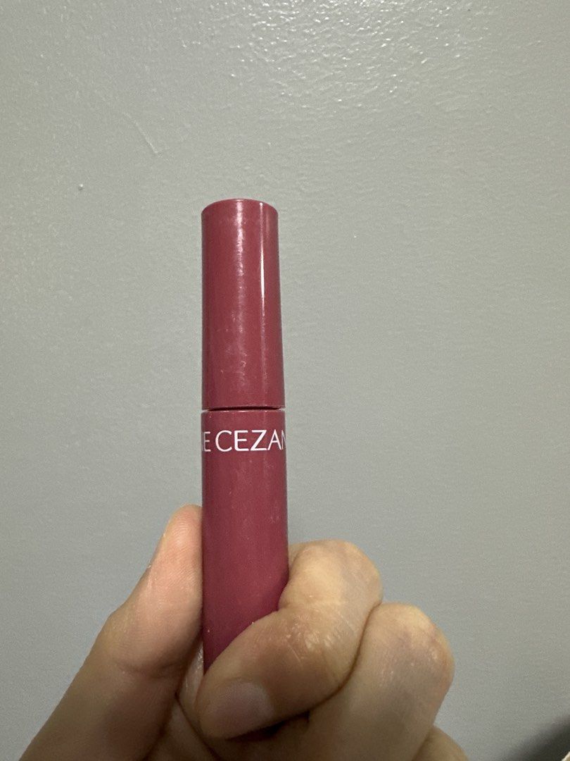 Cezanne Lasting Lip Color (Category: Makeup) located in San Juan City. Submitted by declutterwithxz (Listing ID 1471154684, Image 1). Description: - Brand: Cezanne - Shade: Stunning dark pink - Packaging: Slim pink tube with twist-up mechanism and white branding - Condition: Minor exterior wear from storage, lipstick itself is great - Portability: Compact size, ideal for small handbags and makeup pouches - Perfect for: Quick, everyday touch-ups.