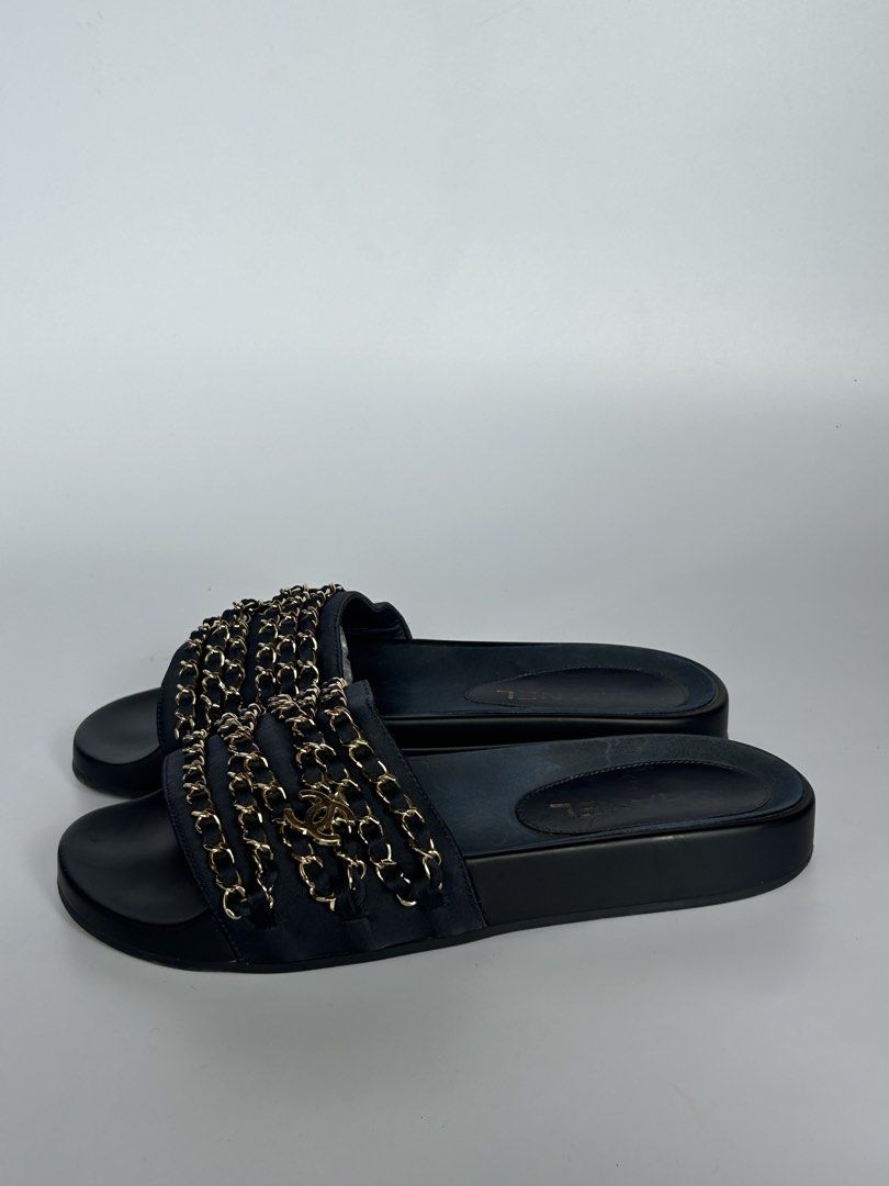 Chanel Black Leather Chain Slides Sandals (Category: Sneakers & Footwear) located in Tacloban City. Submitted by houseofluxury.co (Listing ID 1471191925, Image 3). Description: Chanel black leather slides. Interwoven chain detail across the wide strap with CC logo charm. Smooth footbed with gold Chanel logo stamp. Thick black soles with traction pattern underneath, stamped Made in Italy. Slip-on design, comfortable daily wear. Minimal wear on bot