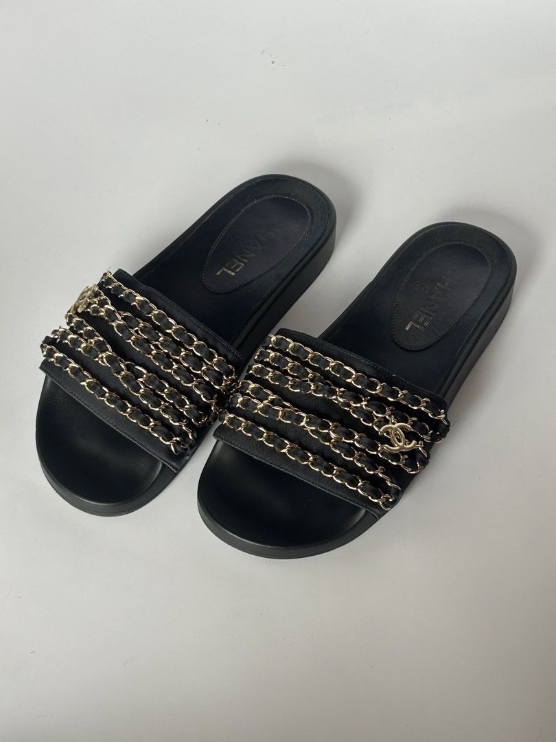 Chanel Black Leather Chain Slides Sandals (Category: Sneakers & Footwear) located in Tacloban City. Submitted by houseofluxury.co (Listing ID 1471191925, Image 1). Description: Chanel black leather slides. Interwoven chain detail across the wide strap with CC logo charm. Smooth footbed with gold Chanel logo stamp. Thick black soles with traction pattern underneath, stamped Made in Italy. Slip-on design, comfortable daily wear. Minimal wear on bot
