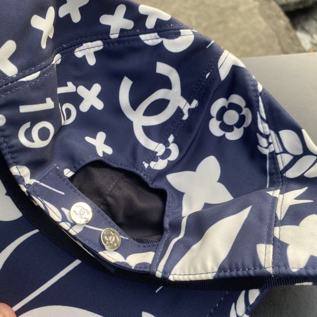 Chanel Blue White Pattern Baseball Cap Hat (Category: Caps & Hats) located in Quezon City. Submitted by capsanywhere (Listing ID 1471193096, Image 2). Description: - 100% authentic Chanel baseball cap in dark blue and white - Features signature CC logo and floral all-over graphic pattern - Adjustable snapback closure with branded metal hardware - Made in Italy, crafted from 100% cotton with clean interior lining - Perfect statement piece to eleva
