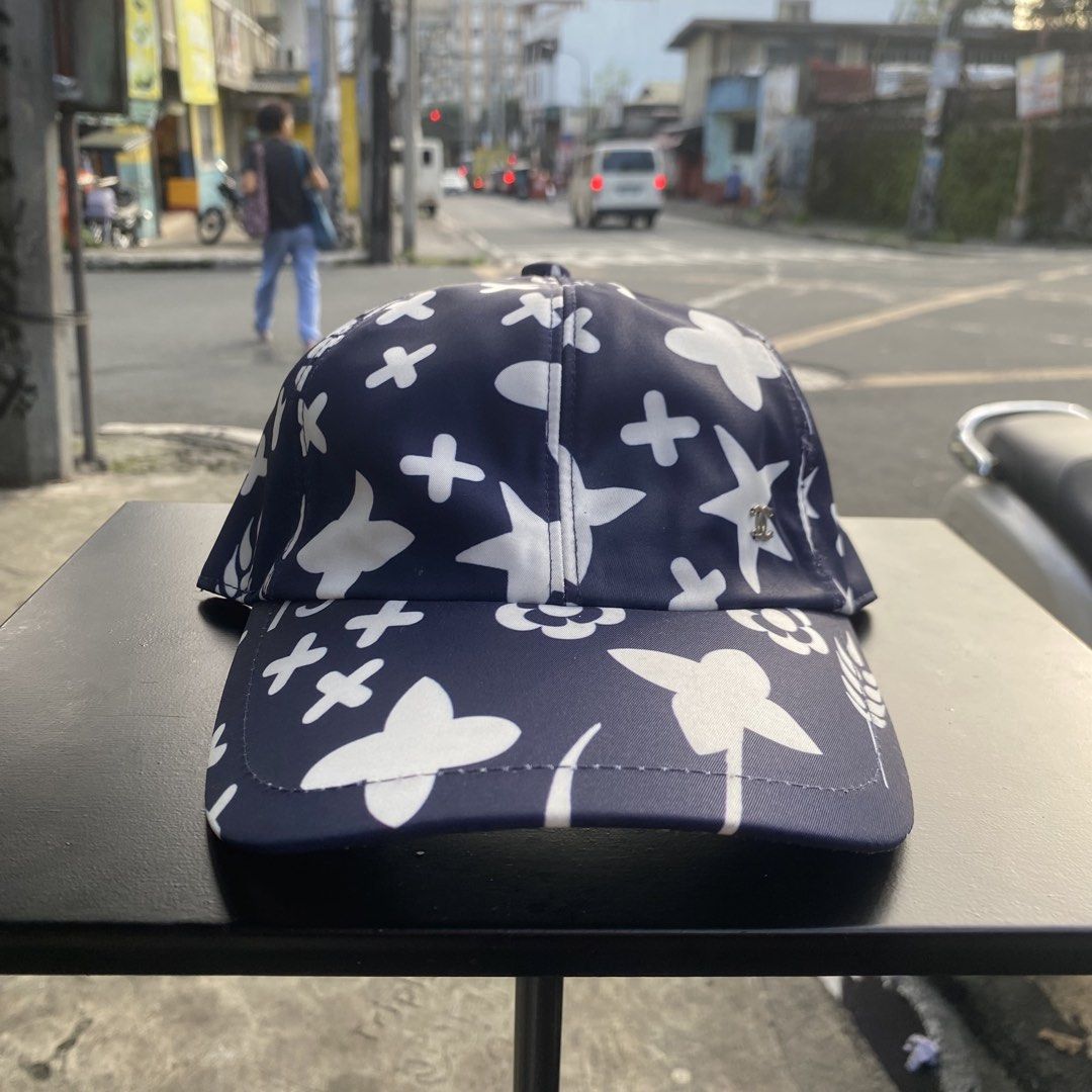 Chanel Blue White Pattern Baseball Cap Hat (Category: Caps & Hats) located in Quezon City. Submitted by capsanywhere (Listing ID 1471193096, Image 1). Description: - 100% authentic Chanel baseball cap in dark blue and white - Features signature CC logo and floral all-over graphic pattern - Adjustable snapback closure with branded metal hardware - Made in Italy, crafted from 100% cotton with clean interior lining - Perfect statement piece to eleva