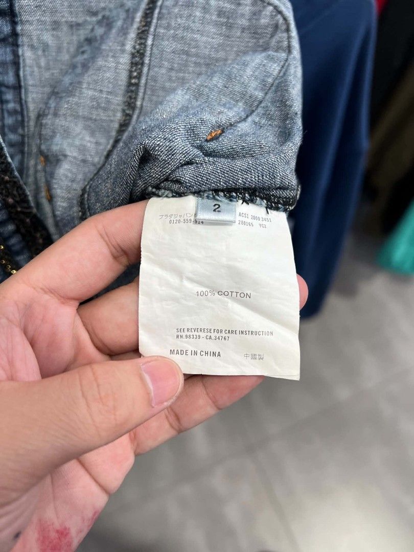 Chanel Denim Zip Jacket Size 2 (Category: Coats, Jackets and Outerwear) located in Urdaneta. Submitted by jayceegarage (Listing ID 1471290737, Image 3). Description: - Brand: Chanel - Item: Blue denim zip jacket - Size: 2 (Tag) - Material: 100% cotton - Details: Ornate dark trim along the neckline, zipper, pockets, and sleeve cuffs - Hardware: Metal YKK front zipper - Pockets: Front patch pockets - Origin: Made in China.