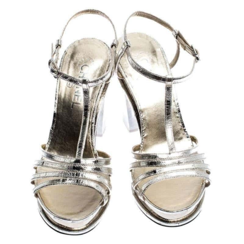 Chanel Metallic Silver Strappy Platform Block Heel Sandals (Category: Sneakers & Footwear) located in Paranaque City. Submitted by calm_youngstore7 (Listing ID 1471170749, Image 2). Description: - Authentic Chanel silver metallic leather strappy sandals - Chic T-strap design with adjustable ankle buckle and multi-strap toe construction - Modern clear chunky block heels and platform soles for added comfort - Features the iconic Chanel logo stamp o