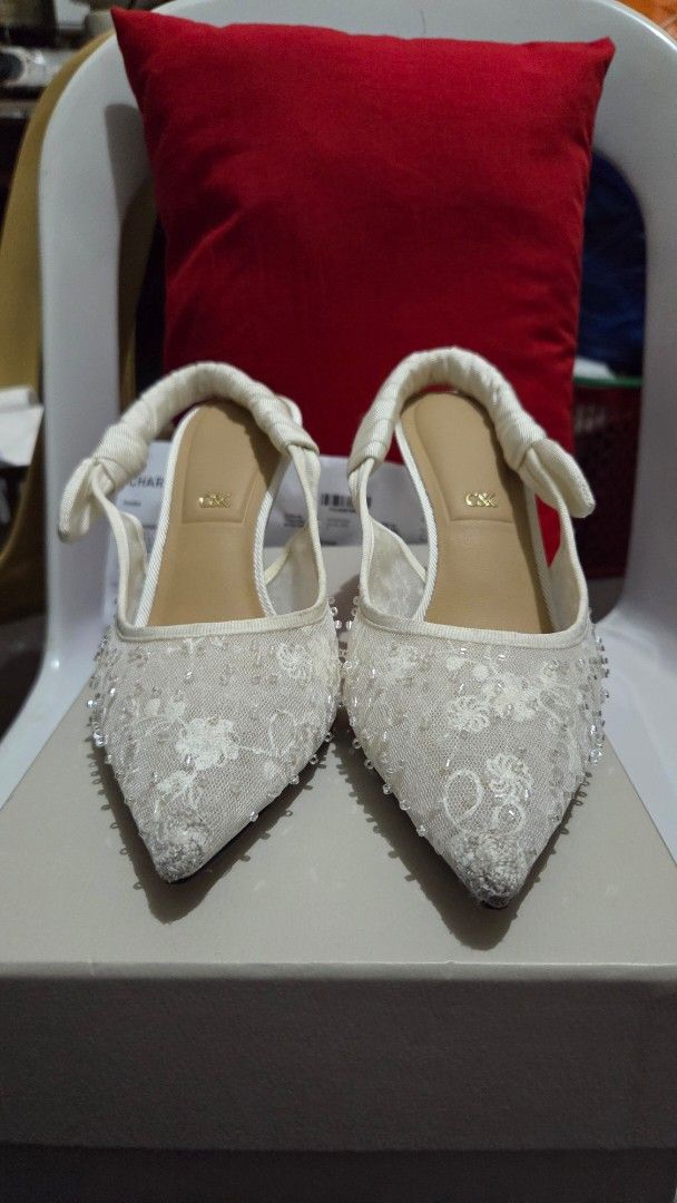 Charles & Keith White Beaded Lace Slingback Heels (Category: Heels) located in Manila. Submitted by lealee12 (Listing ID 1471269038, Image 2). Description: - Brand: Charles & Keith - Color: white - Style: Pointed toe stiletto high heels with slingback strap - Details: Lace mesh fabric covered in tiny beads and sequins, ruched ribbon detail, and metal C&K logo charm - Condition: Includes original box & receipt, worn once - Perfect for formal event