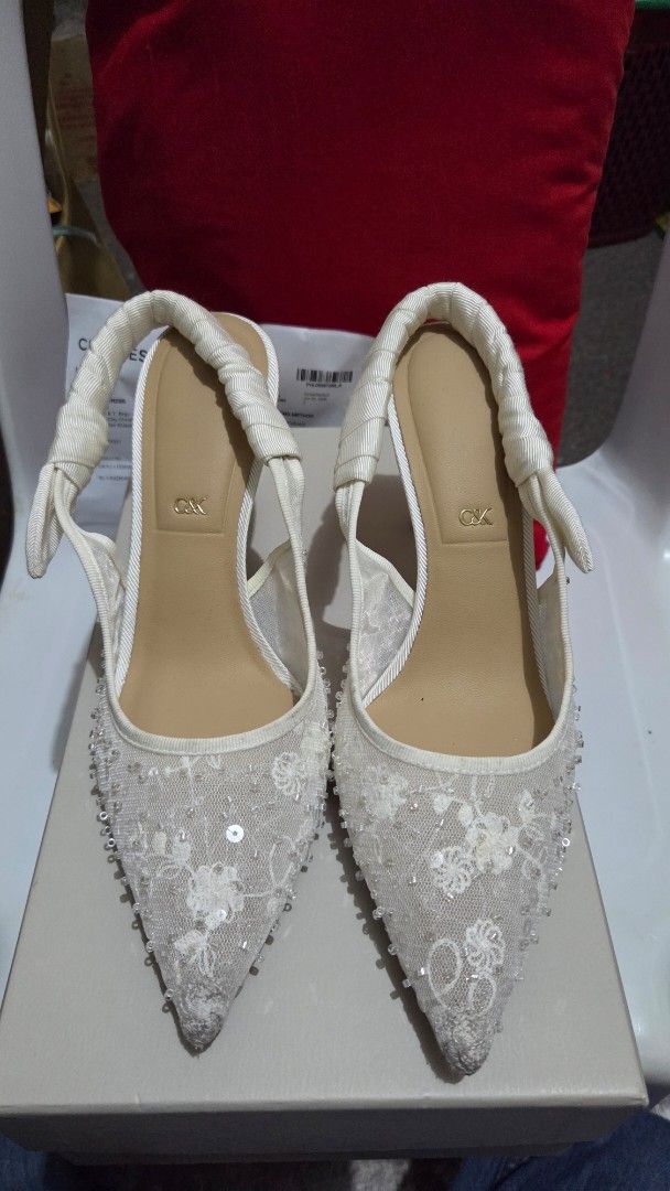 Charles & Keith White Beaded Lace Slingback Heels (Category: Heels) located in Manila. Submitted by lealee12 (Listing ID 1471269038, Image 1). Description: - Brand: Charles & Keith - Color: white - Style: Pointed toe stiletto high heels with slingback strap - Details: Lace mesh fabric covered in tiny beads and sequins, ruched ribbon detail, and metal C&K logo charm - Condition: Includes original box & receipt, worn once - Perfect for formal event