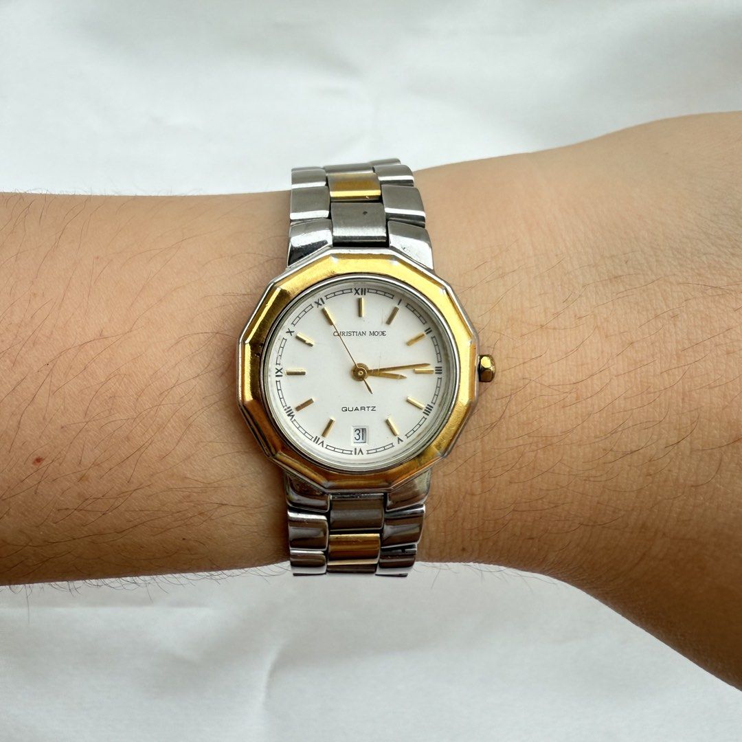 Christian Mode CM-009L Two-Tone Quartz Watch (Category: Women's Watches) located in Cagayan de Oro. Submitted by sbabs1996 (Listing ID 1471255897, Image 1). Description: - Brand: Christian Mode - Model: CM-009L (stamped on caseback) - Movement: Battery-operated quartz analog - Strap: Two-tone silver and gold stainless steel bracelet - Dial: Clean white dial with classic Roman numerals - Features: Date window at the 6 o'clock position - Design: El