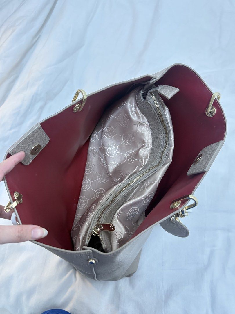 CLN Grey Tote Bag with Gold Hardware (Category: Tote Bags) located in Manila. Submitted by k.e9999 (Listing ID 1471263325, Image 3). Description: - Brand: CLN - Material: Grey faux leather with a structured design - Interior: Vibrant red silky fabric lining with patterned compartments - Organization: Multiple zippered sections to keep your essentials secure - Details: Elegant gold chain links on the shoulder straps and a matching front charm - Ca