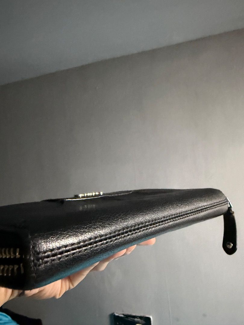 Coach Black Leather Zip Around Wallet (Category: Wallets & Card holders) located in Quezon City. Submitted by silentstar.3e0b05 (Listing ID 1471186234, Image 2). Description: - Brand: Coach - Color: Classic Black with Silver Hardware - Material: Genuine soft-grain leather - Design: Elegant pleated front with Coach script logo - Closure: Secure all-around zipper with leather pull tab - Interior: Spacious compartments with plenty of room for cards 