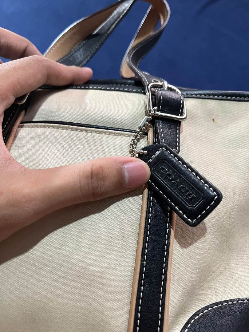Coach Canvas & Leather Tote Bag. (Category: Tote Bags) located in Manila. Submitted by jenyjoy (Listing ID 1471288297, Image 2). Description: ​Details: ​Adjustable flat leather shoulder straps with silver-tone metal buckles. ​Front exterior slide pocket with leather piping. ​Zip-top main compartment closure. ​Black leather corner guards at the base for added durability. ​Black leather Coach hangtag on a silver ball-chain. -chain..