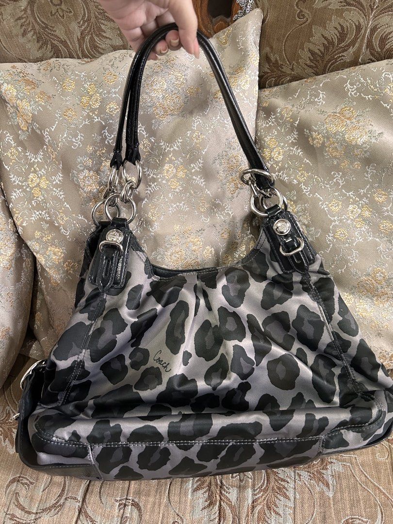Coach Gray Leopard Print Shoulder Bag Purse (Category: Luxury Bags & Wallets) located in Caloocan City. Submitted by atamssss (Listing ID 1471231243, Image 2). Description: - Authentic Coach shoulder bag in grey and black leopard print - Shiny black leather straps and sleek silver hardware - Triple-compartment design: center zip compartment + two open side compartments with snap closures - Vibrant purple fabric lining with interior zipper and sli