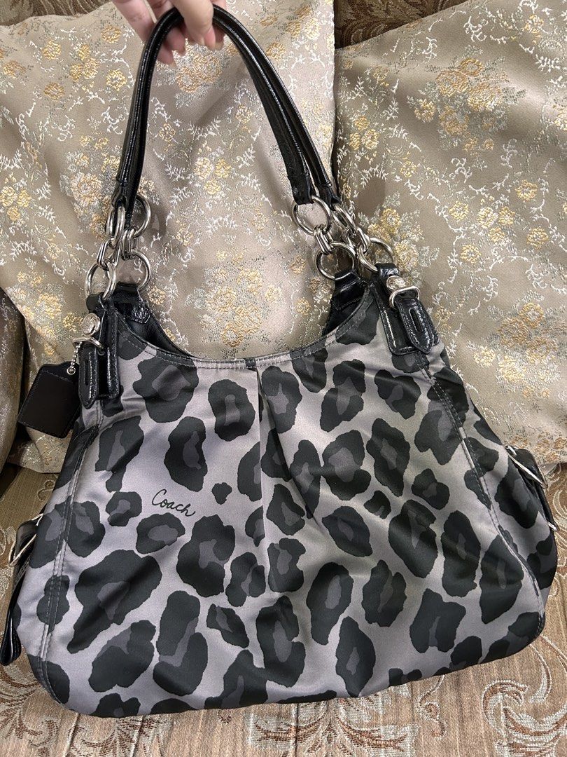 Coach Gray Leopard Print Shoulder Bag Purse (Category: Luxury Bags & Wallets) located in Caloocan City. Submitted by atamssss (Listing ID 1471231243, Image 1). Description: - Authentic Coach shoulder bag in grey and black leopard print - Shiny black leather straps and sleek silver hardware - Triple-compartment design: center zip compartment + two open side compartments with snap closures - Vibrant purple fabric lining with interior zipper and sli
